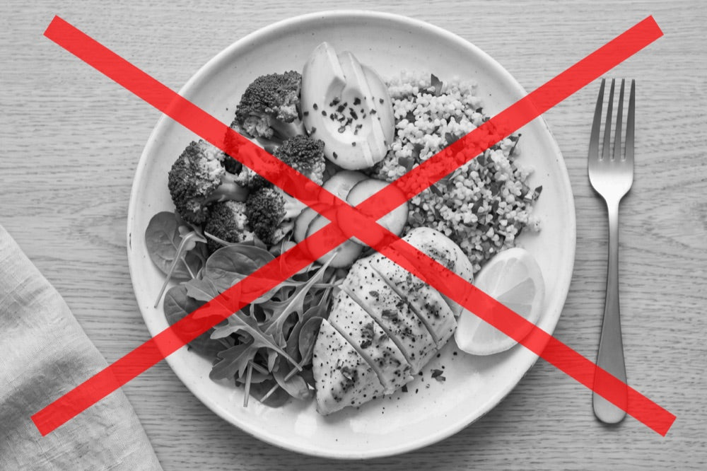 Black-and-white photo of a clean-eating plate, crossed out in red